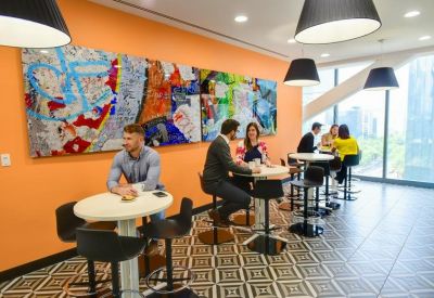 Dining area with colorful artwork on the wall.