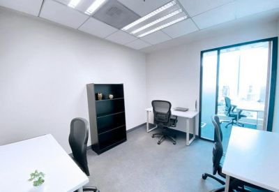 Private office with multiple desks and modern chairs.