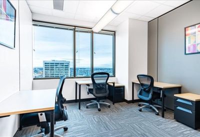 Three-person private office suite with large windows and city views.