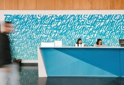 Reception area with blue patterned wall and desk.
