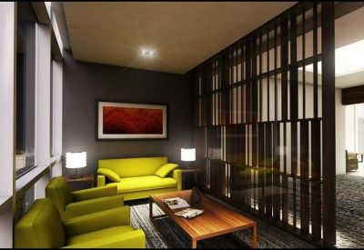 Lounge area with lime green sofas and dark wood slatted partition.