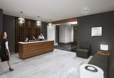 Professional reception desk with wood paneling and a modern seating area.