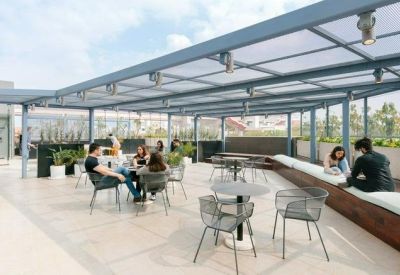 Outdoor rooftop terrace with a shaded canopy and multiple seating areas for informal meetings.