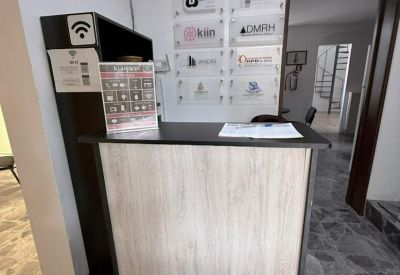 Reception area with a light wood front desk and directory of resident businesses.
