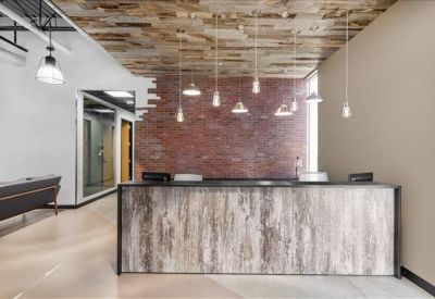 Modern reception area with a wood-textured front desk and decorative hanging lights.