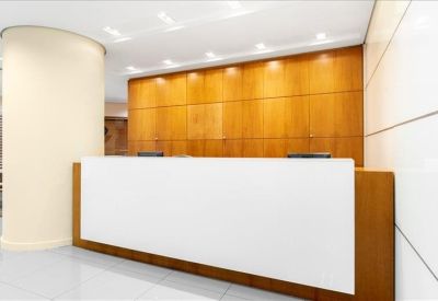 Clean white reception desk backed by a warm wood-paneled wall.