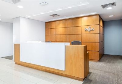 Modern reception desk with wood paneling and a large white counter front.