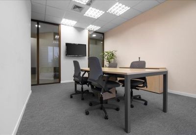 Professional four-person meeting room with a wall-mounted TV and glass partitions.
