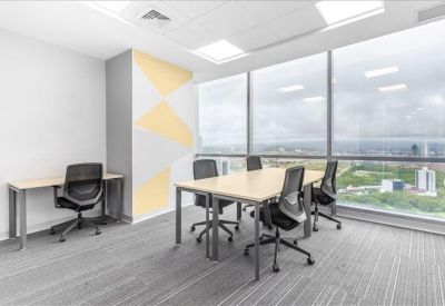Team workspace featuring a light wood table and yellow geometric wall art.