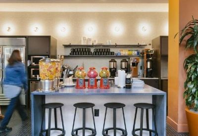 Communal kitchen area with a breakfast bar, blue counter, and gumball machines.