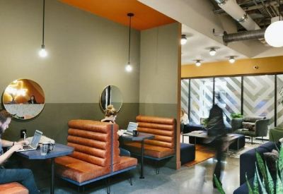Breakout space featuring leather booths, round mirrors, and warm pendant lighting.
