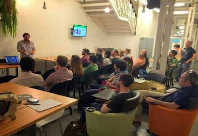 Presentation area with rows of chairs and a speaker at the front.