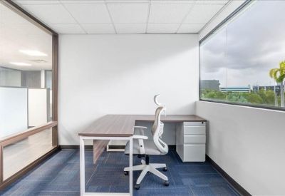Private corner office featuring an L-shaped desk and views of the surrounding area.