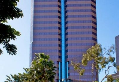Portrait view of the tall glass and brick facade of One World Trade Centre.