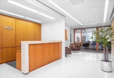 Bright professional reception area with a wood-fronted desk and polished white floors.