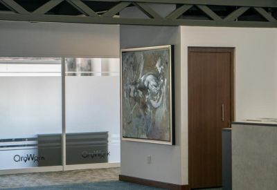 Open communal area featuring abstract paintings and a decorative wooden door.