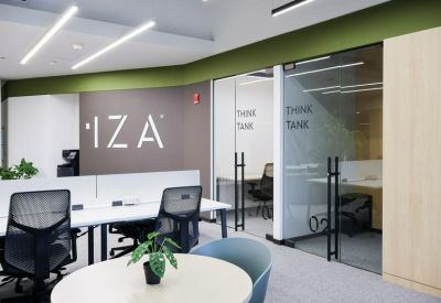 Modern reception area featuring a branded wall and glass-walled meeting rooms.
