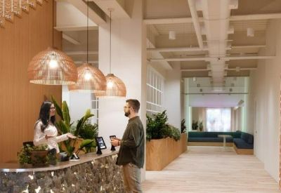 Reception desk with textured metallic finish and warm pendant lighting.