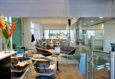 Contemporary reception lobby with designer chairs and glass partitions.