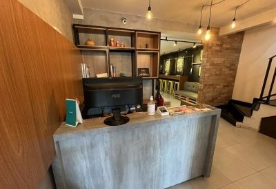 Reception desk with wood paneling and a modern computer setup.