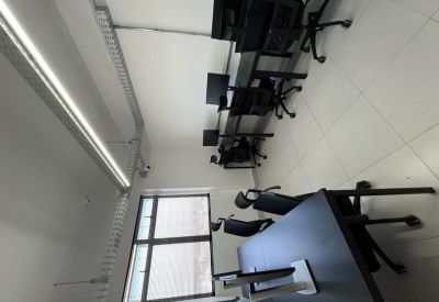 Private office space featuring three workstations with black monitors and chairs.