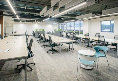 Wide view of a collaborative office floor with various seating and workstations.