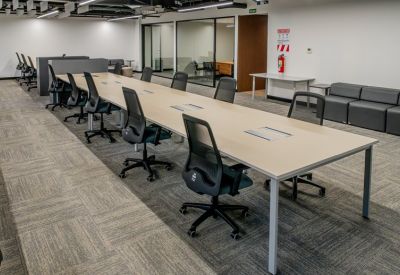 Communal break area with grey modular seating and a small round cafe table.