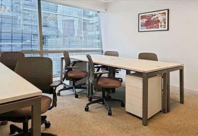Bright, modern meeting room with glass windows, white desks, and grey mesh chairs.