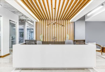Bright reception desk with a distinctive slatted wood feature wall and ceiling design.