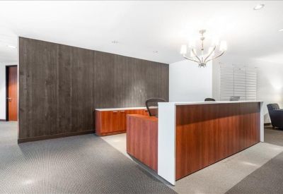 Sleek reception area featuring a wood-paneled front desk and modern chandelier.