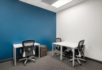 Private office with two desks and a blue accent wall.