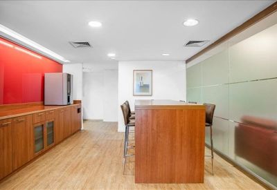 Breakout area featuring a high wooden table and a vibrant red accent wall.