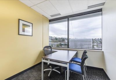 Private office with a desk, two chairs, and a large window with city views.