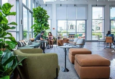 Bright lounge area with modern seating and large windows.