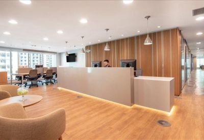 Sleek reception area with grey stone walls and pendant lighting.