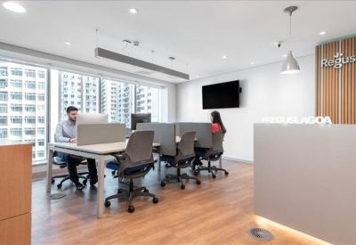 Bright coworking area with workstations and city views.