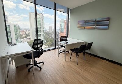 Private office with two desks, ergonomic chairs, and large windows overlooking the city.