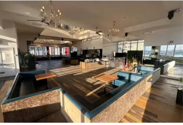 Spacious communal lounge at 617, West 46th Street, 6 fl with chandeliers and natural light.