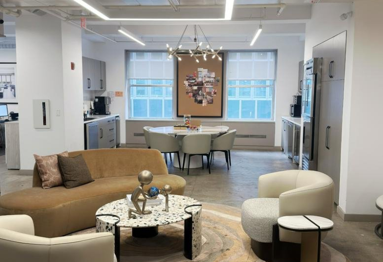 Spacious communal lounge with warm seating and a round marble table at 125, Maiden Lane, 14A.