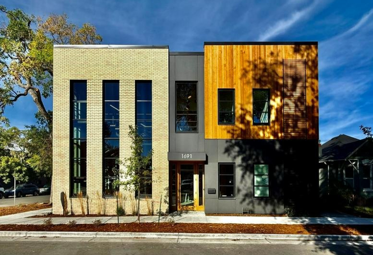 Exterior of 1691, South Pearl Street featuring a mix of brick, wood, and grey siding.