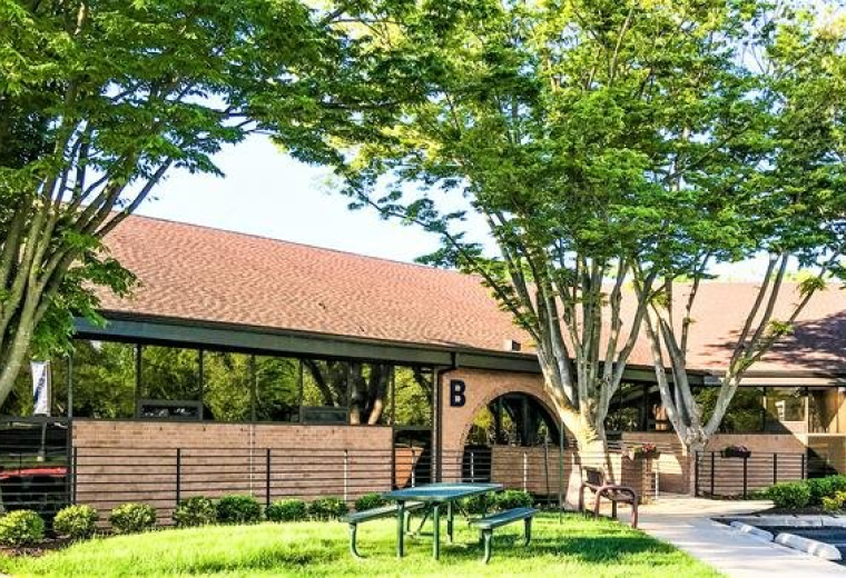 Exterior view of brick office building with green landscaping at 10015 Old Columbia Rd, Suite B215, Columbia.