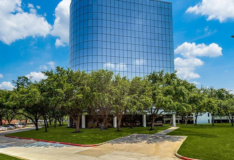 Exterior view of the blue glass curved facade at 11011 Richmond Avenue.