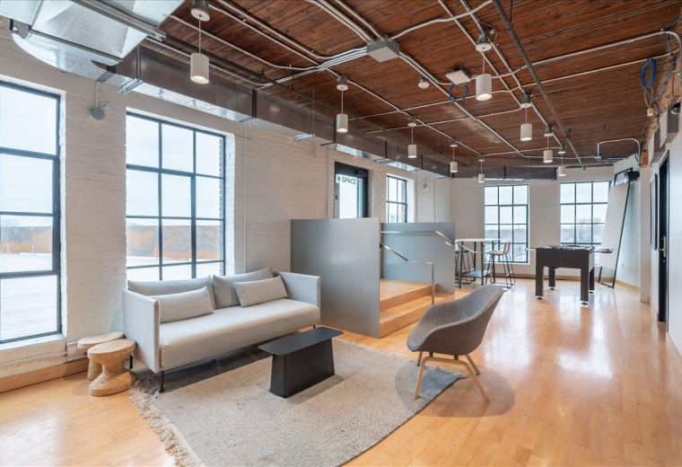 Professional wooden reception desk at 1655 Dupont Street, Suite 101 with modern pendant lighting.