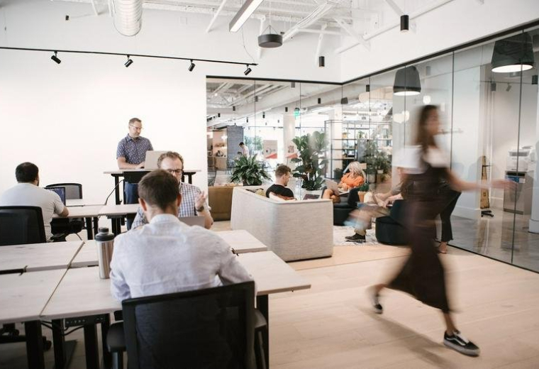 Bright open-plan office at 26 South Rio Grande Street, The Gateway, featuring various workstations and plants.