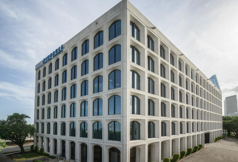 Exterior view of the white, grid-facade building at 3120 Southwest Freeway.