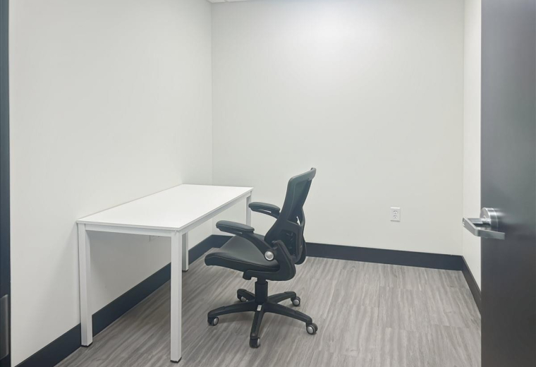 Private office suite at 3293 Harrison Boulevard featuring a white desk and ergonomic chair.