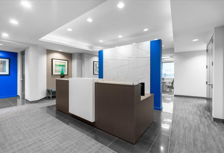 Professional reception desk at 10 Milner Business Court with modern white and blue accents.