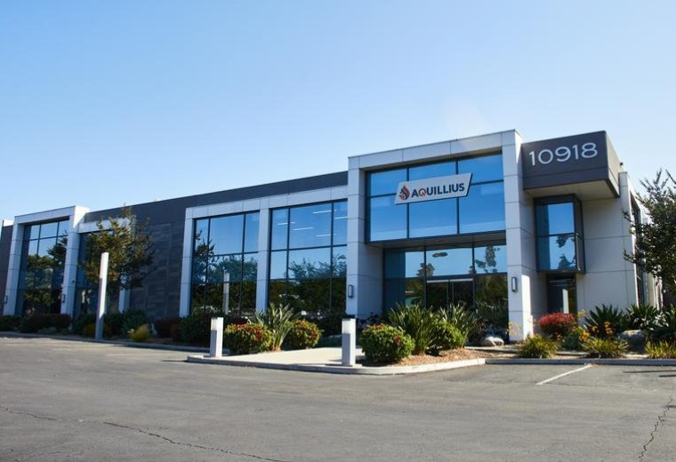 Modern exterior facade of 10918 Technology Place with glass windows and prominent address signage.