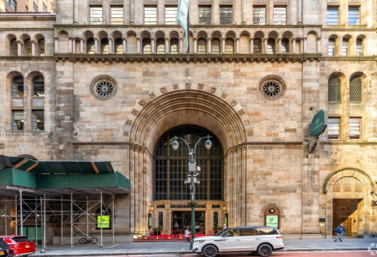 Ornate stone facade and grand arched entrance of the 110 East 42nd Street building.