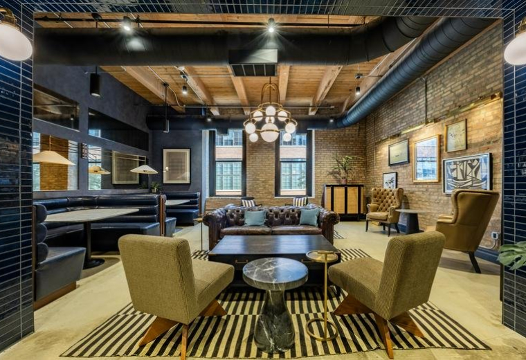Lounge area at 1101 West Lake Street with brick walls and eclectic seating.
